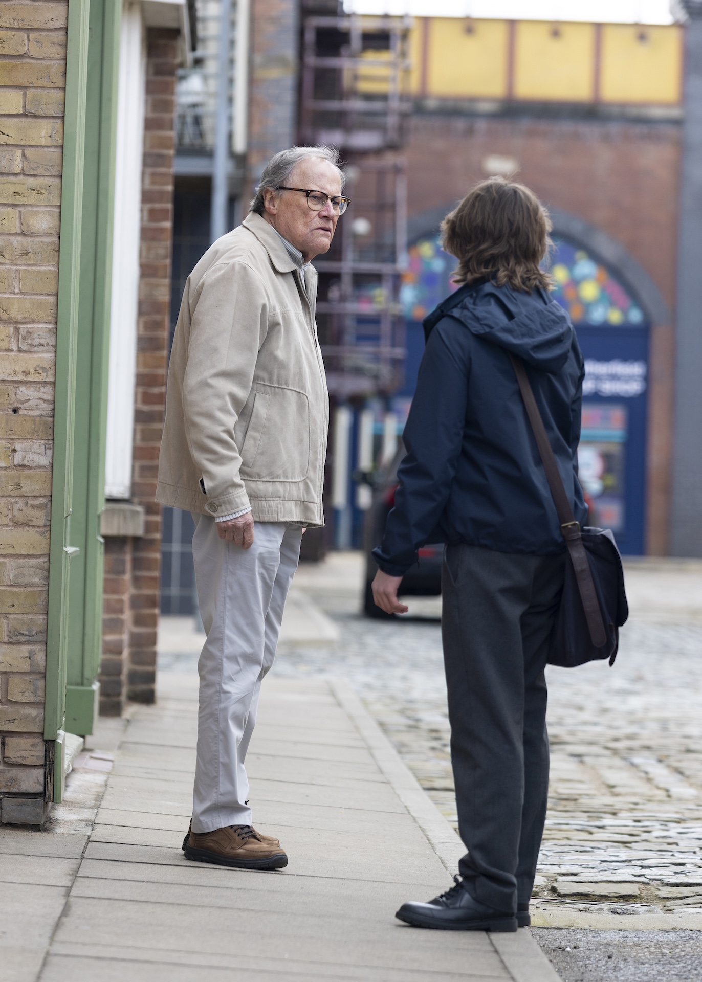 Sam and Roy talking outside in Coronation Street