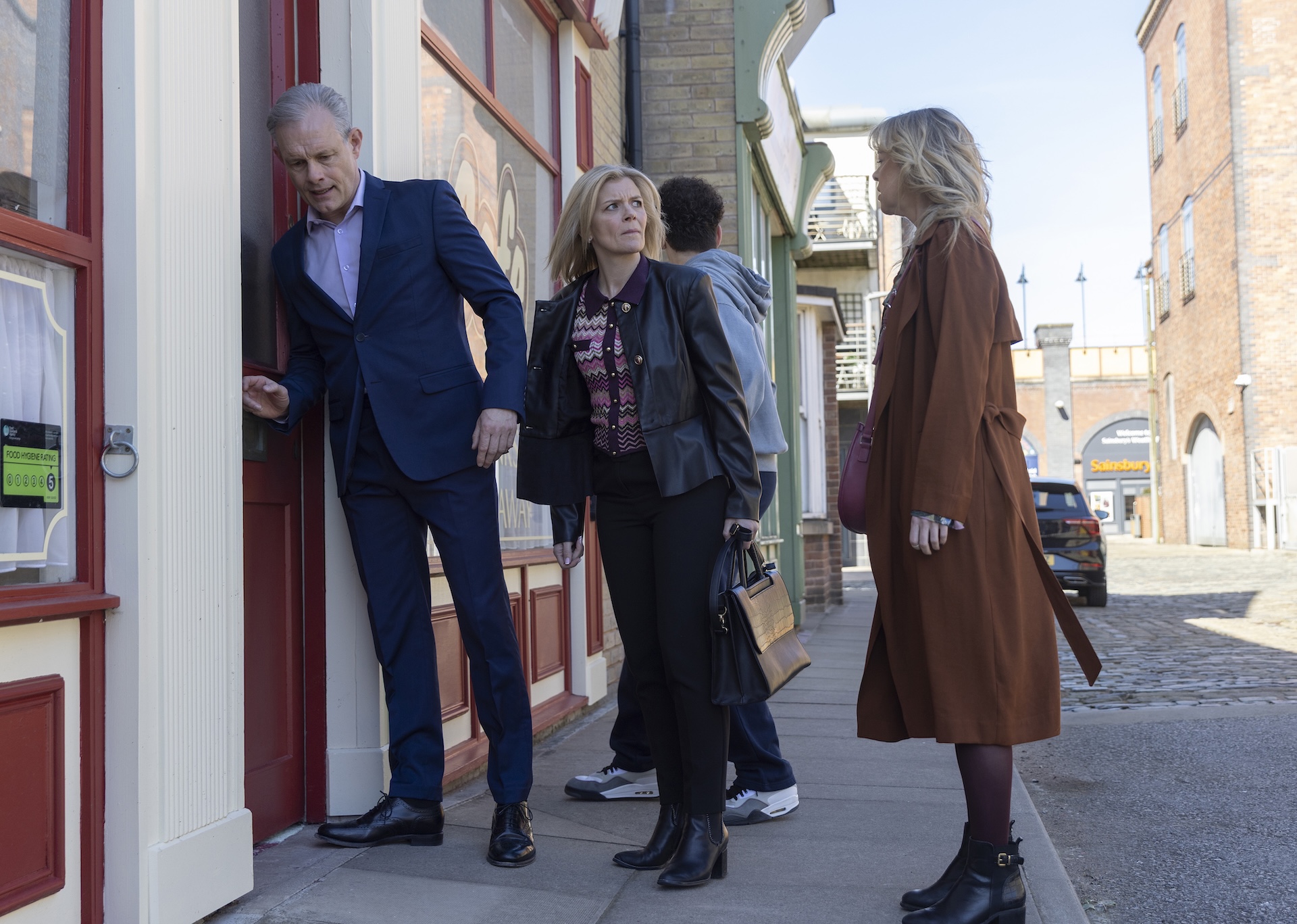 Nick, Leanne and Toyah outside Roy's Rolls in Coronation Street