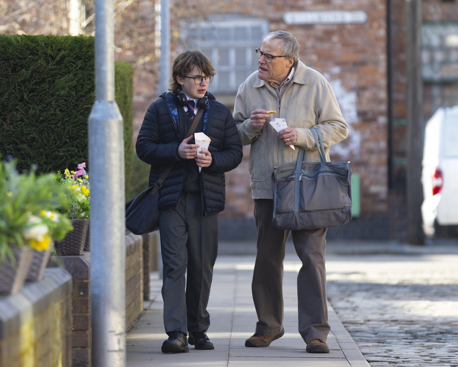 Sam and Roy eating chips outside in Coronation Street