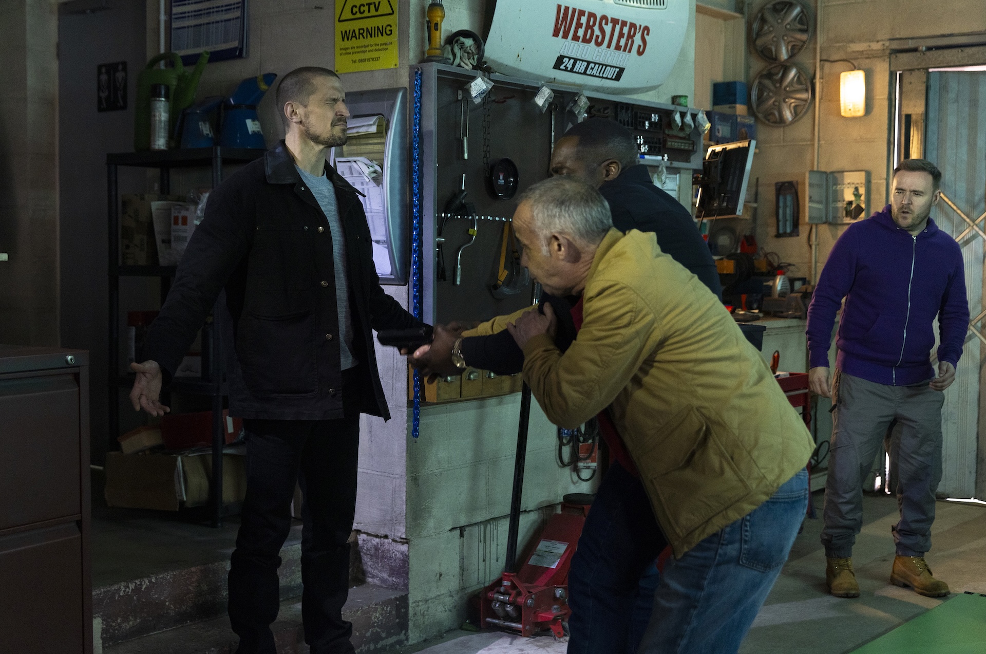 Kevin and Ronnie fighting Carl for the gun in Coronation Street